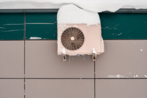 HVAC unit covered with snow