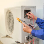 Technician tinkering with an HVAC system’s Anderson, IN