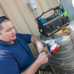 technician repairing a malfunctioning HVAC system Fishers, IN