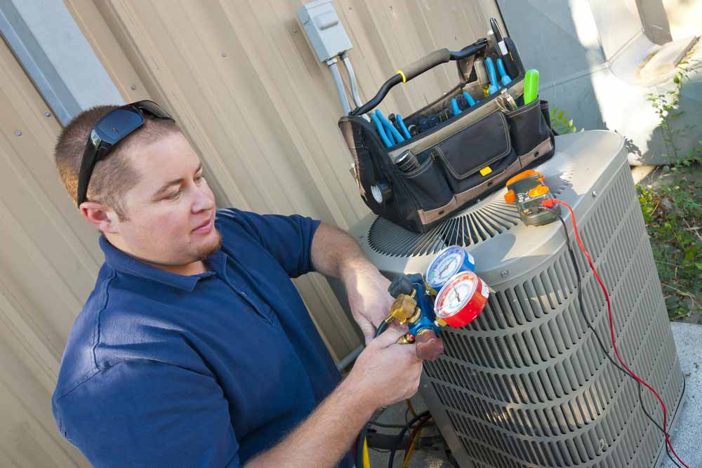 technician repairing a malfunctioning HVAC system Fishers, IN